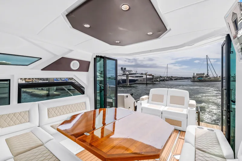 Slide: The Image of Luxurious interior of 2019 Beneteau Gran Turismo 46 yacht with elegant seating and wooden table. - 32