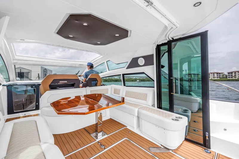 Slide: The Image of Luxurious interior of 2019 Beneteau Gran Turismo 46 yacht with elegant seating and wooden table. - 33