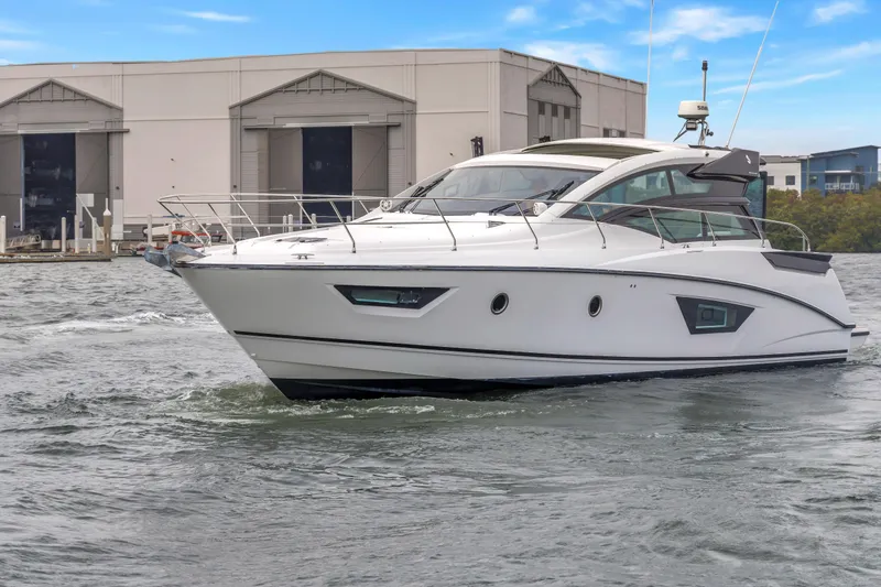 Slide: The Image of 2019 Beneteau Gran Turismo 46 yacht cruising near industrial buildings. - 4