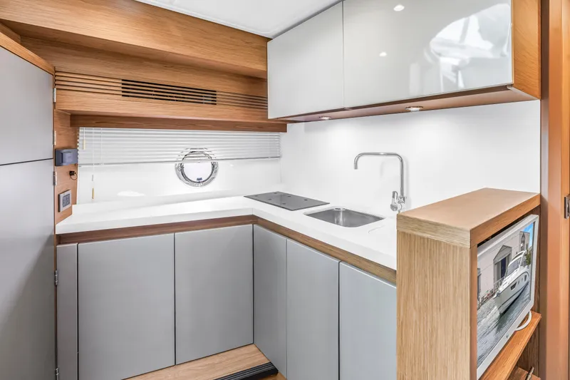 Slide: The Image of Modern kitchen interior of 2019 Beneteau Gran Turismo 46 yacht with sleek cabinetry. - 40