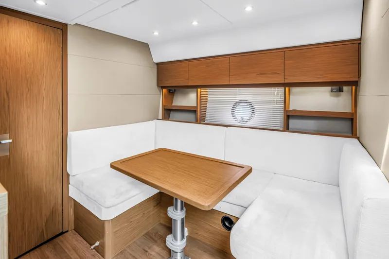 Slide: The Image of Interior of 2019 Beneteau Gran Turismo 46 yacht with cozy seating and wooden table. - 42