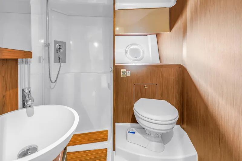 Slide: The Image of Luxurious bathroom in 2019 Beneteau Gran Turismo 46 yacht with modern fixtures and wood accents. - 49