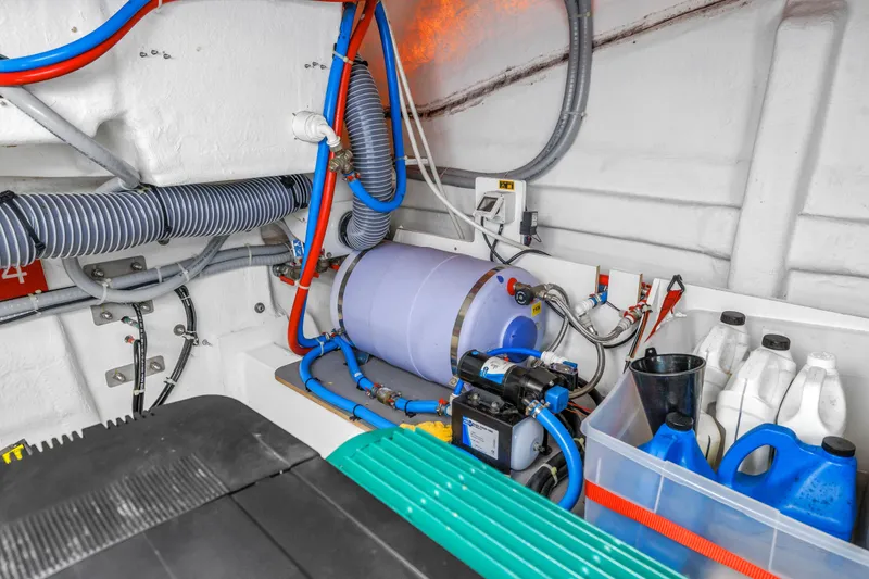 Slide: The Image of Engine room of 2019 Beneteau Gran Turismo 46 with hoses and equipment. - 57