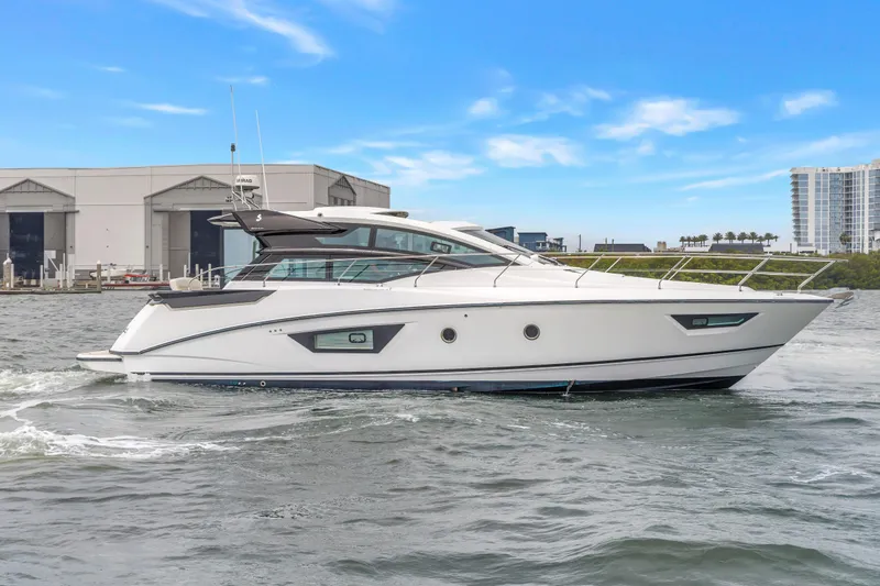 Slide: The Image of 2019 Beneteau Gran Turismo 46 yacht cruising on water near marina. - 6