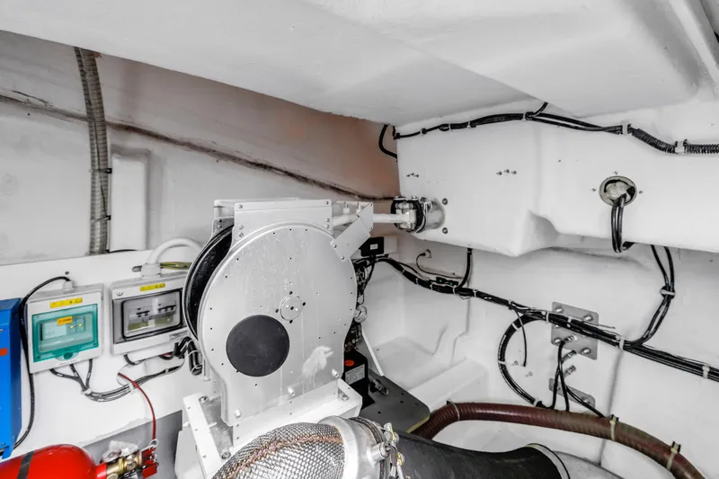 Slide: The Image of Engine room of 2019 Beneteau Gran Turismo 46 yacht, showcasing mechanical components and wiring. - 64