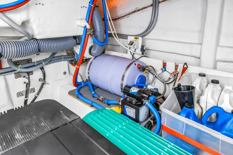 Slide: The Image of Engine room of 2019 Beneteau Gran Turismo 46 with mechanical components and storage containers. - 65