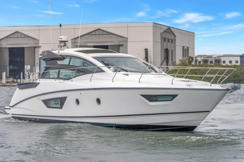 Slide: The Image of 2019 Beneteau Gran Turismo 46 yacht cruising near industrial buildings. - 67