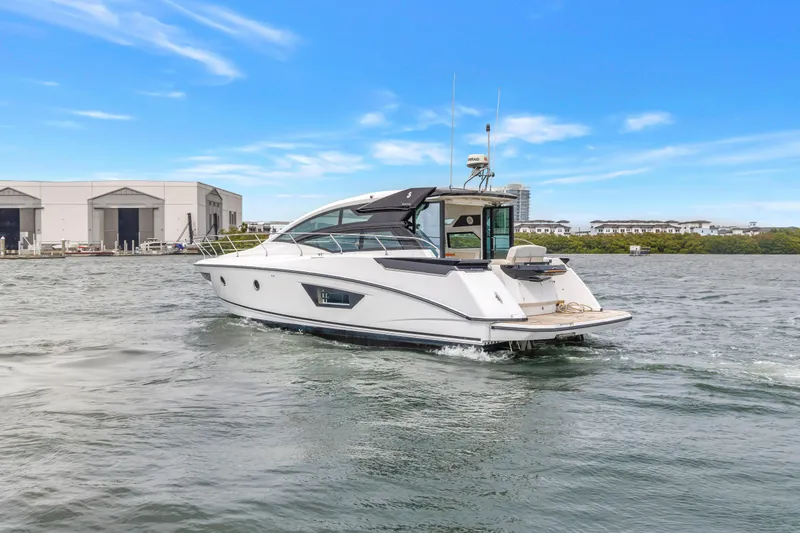 Slide: The Image of 2019 Beneteau Gran Turismo 46 yacht cruising on a sunny day near a marina. - 7