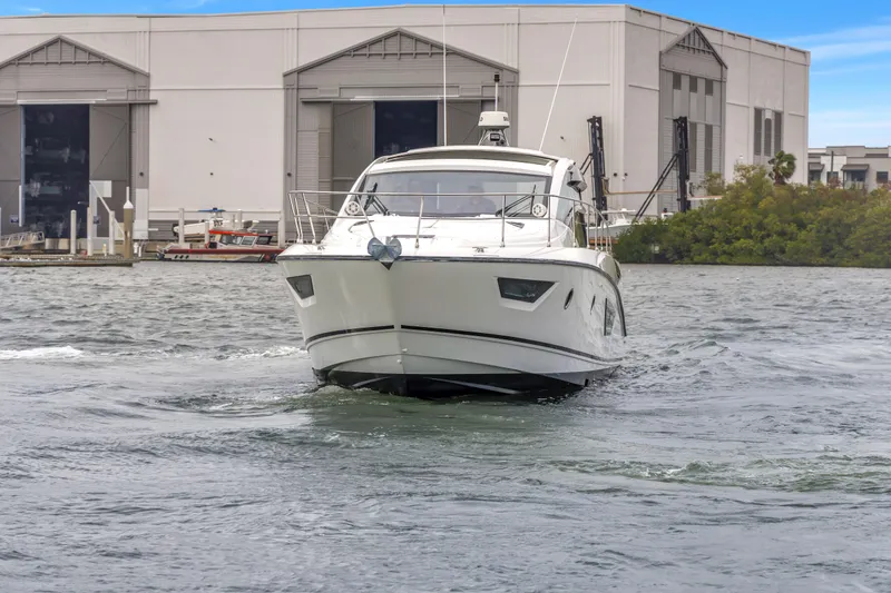 Slide: The Image of 2019 Beneteau Gran Turismo 46 yacht cruising near industrial buildings. - 73