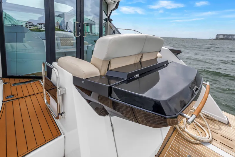 Slide: The Image of 2019 Beneteau Gran Turismo 46 yacht deck with seating and ocean view. - 9