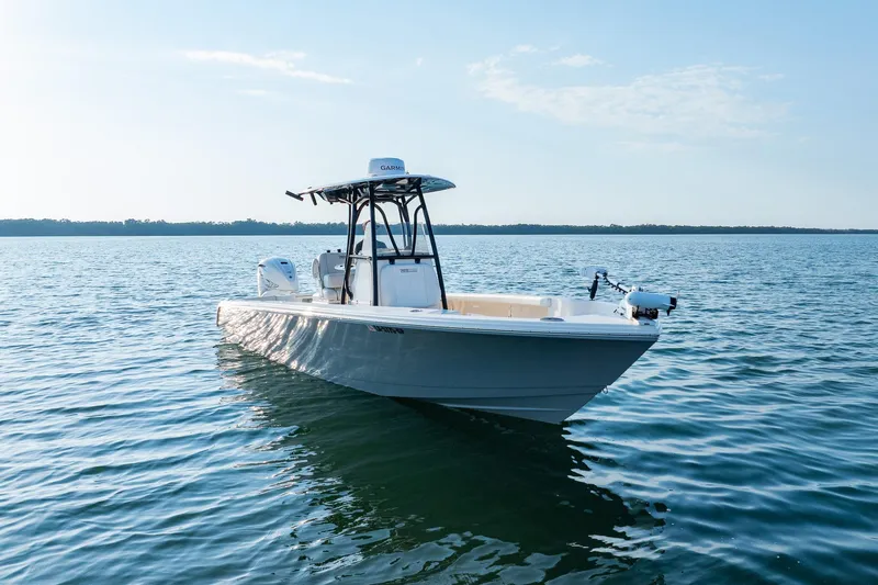 Slide: The Image of 2023 Pathfinder 2700 Open boat on calm water under clear sky. - 12