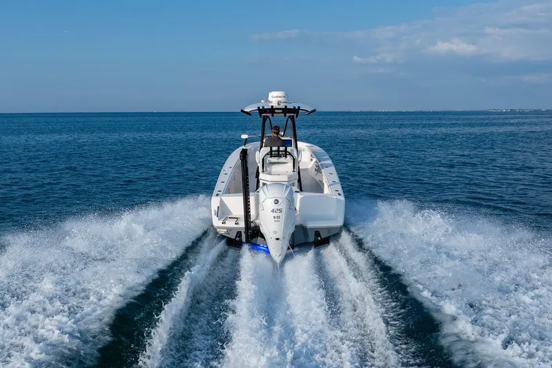 Slide: The Image of 2023 Pathfinder 2700 Open boat cruising on open water, rear view. - 17