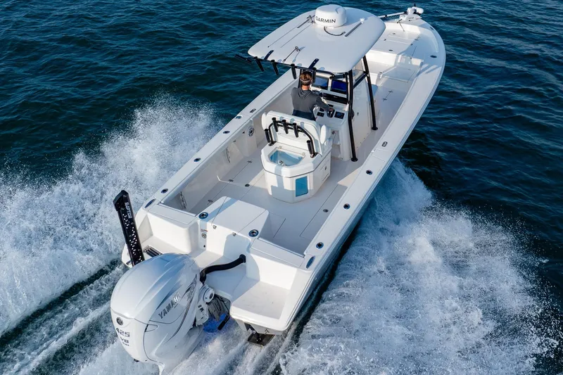 Slide: The Image of 2023 Pathfinder 2700 Open boat cruising on water, rear view. - 20