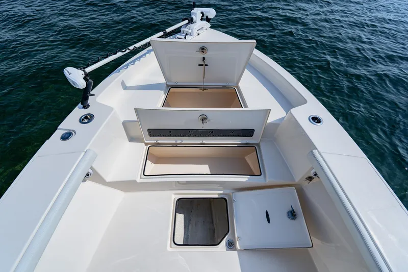 Slide: The Image of 2023 Pathfinder 2700 Open boat with open storage compartments on calm water. - 23