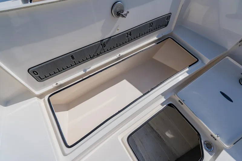 Slide: The Image of 2023 Pathfinder 2700 Open boat storage compartment with measuring scale. - 25