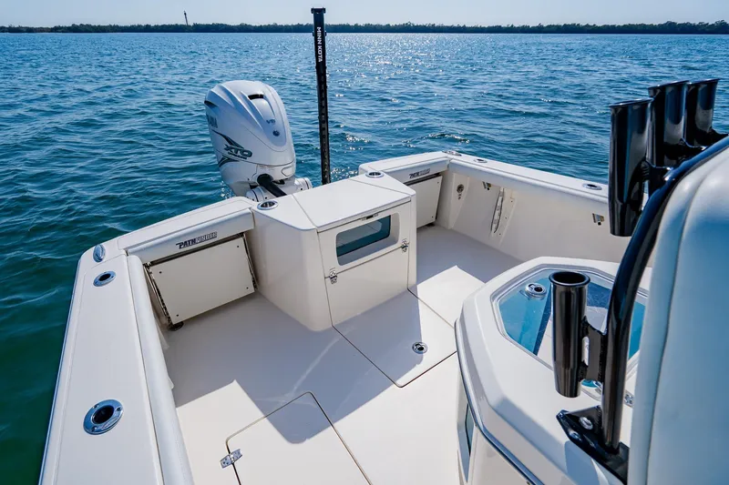 Slide: The Image of 2023 Pathfinder 2700 Open boat on water, featuring spacious deck and modern outboard motor. - 51