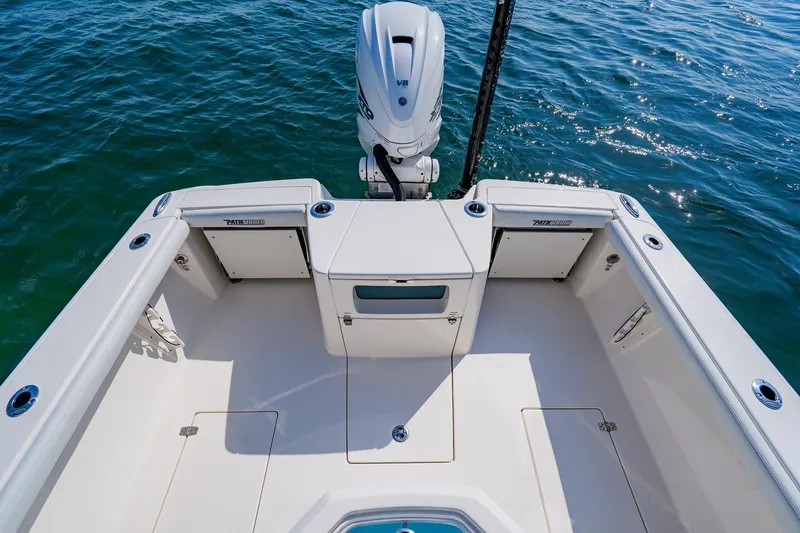 Slide: The Image of 2023 Pathfinder 2700 Open boat deck with motor, on calm blue water. - 52