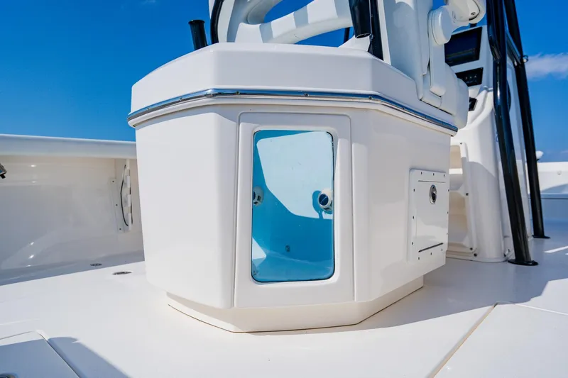 Slide: The Image of 2023 Pathfinder 2700 Open boat console with storage compartment under clear blue sky. - 55