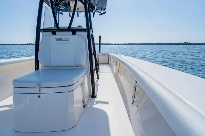 Slide: The Image of 2023 Pathfinder 2700 Open boat interior with seating, on calm blue water. - 58