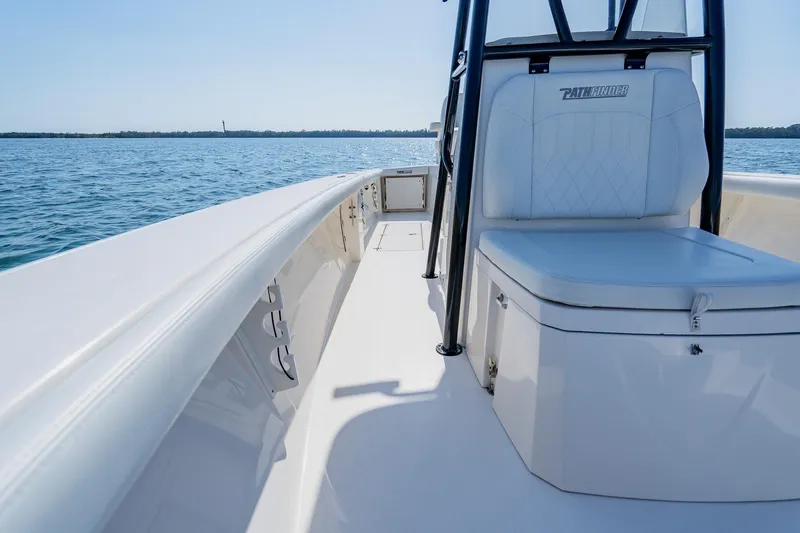 Slide: The Image of 2023 Pathfinder 2700 Open boat on calm water, featuring sleek seating and modern design. - 59