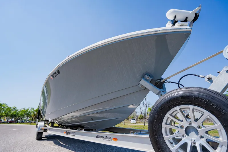 Slide: The Image of 2023 Pathfinder 2700 Open boat on trailer, viewed from below against clear blue sky. - 6