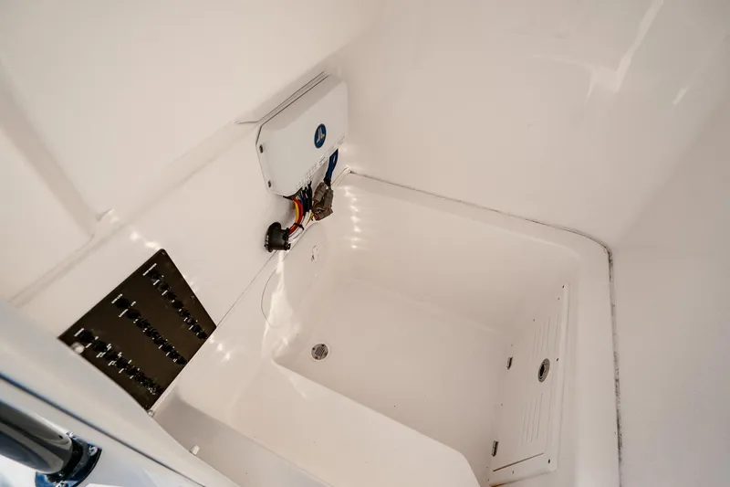 Slide: The Image of 2023 Pathfinder 2700 Open boat interior compartment with wiring and drainage system. - 61