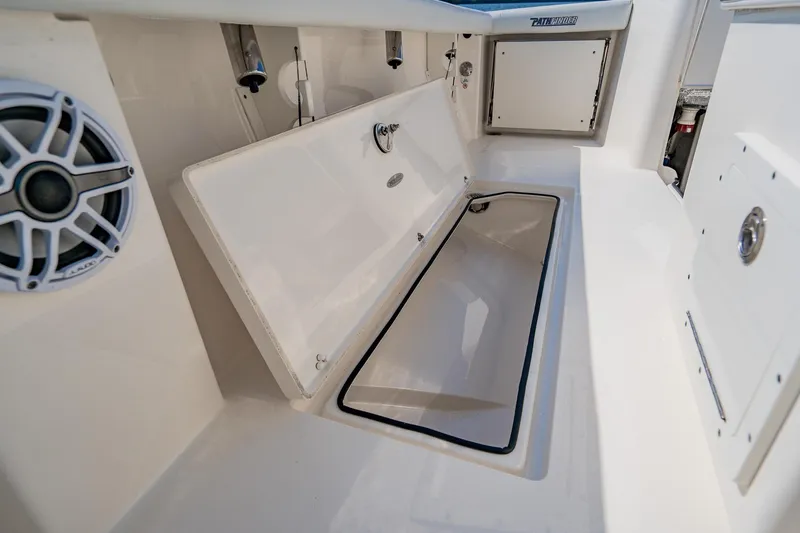 Slide: The Image of 2023 Pathfinder 2700 Open boat interior with storage compartment and speaker. - 65