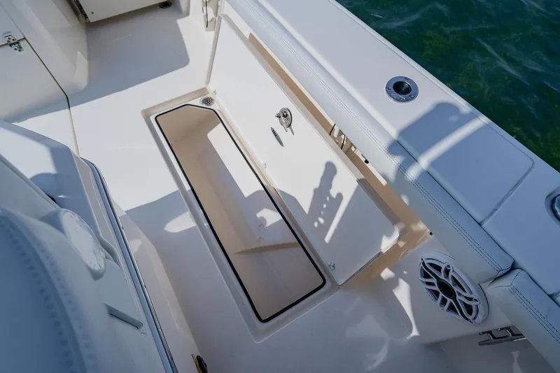 Slide: The Image of 2023 Pathfinder 2700 Open boat storage compartment with sleek design and marine speaker. - 66