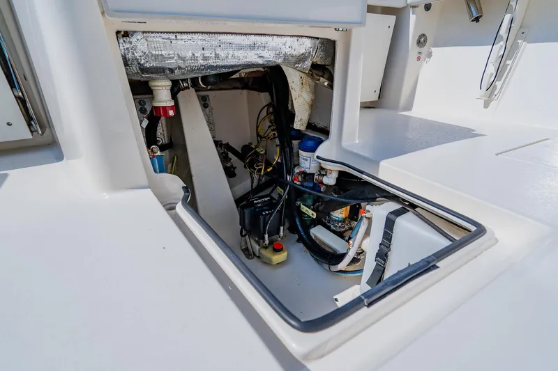 Slide: The Image of 2023 Pathfinder 2700 Open boat interior compartment with visible wiring and components. - 68