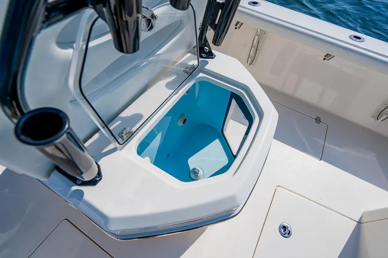 Slide: The Image of 2023 Pathfinder 2700 Open boat with open storage compartment, featuring sleek design and ocean backdrop. - 71