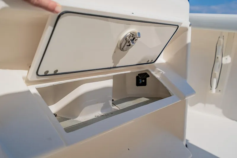 Slide: The Image of Storage compartment on 2023 Pathfinder 2700 Open boat with USB port and secure latch. - 76