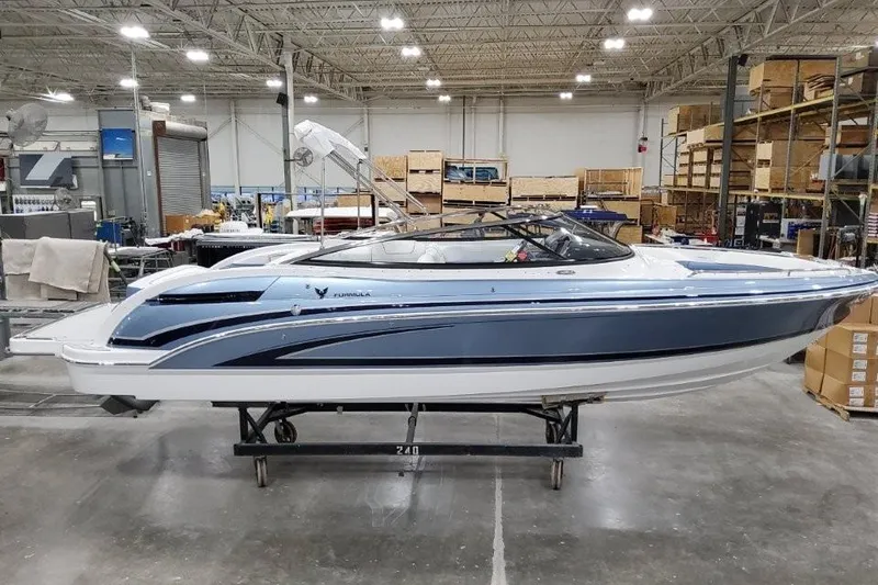 The Image of 2026 Formula 240 Bowrider boat in a warehouse setting, showcasing sleek design. - 0