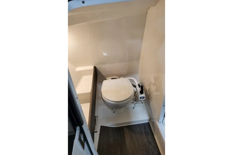 Slide: The Image of 2026 Formula 240 Bowrider boat interior with compact marine toilet. - 13