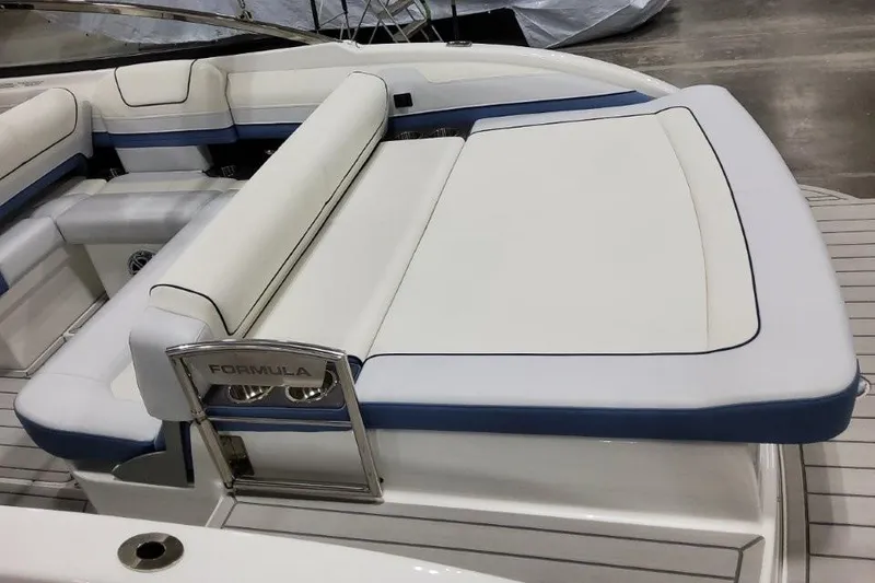 Slide: The Image of 2026 Formula 240 Bowrider boat interior with white and blue seating. - 14
