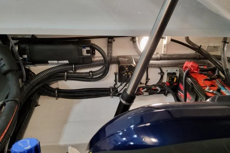 Slide: The Image of Engine compartment of 2026 Formula 240 Bowrider with wiring and battery components. - 21