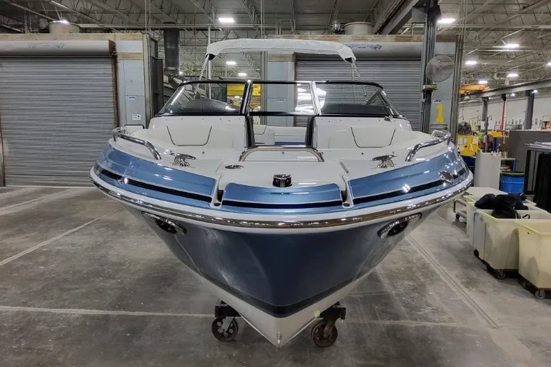 Slide: The Image of 2026 Formula 240 Bowrider boat in a warehouse, showcasing sleek design and modern features. - 3
