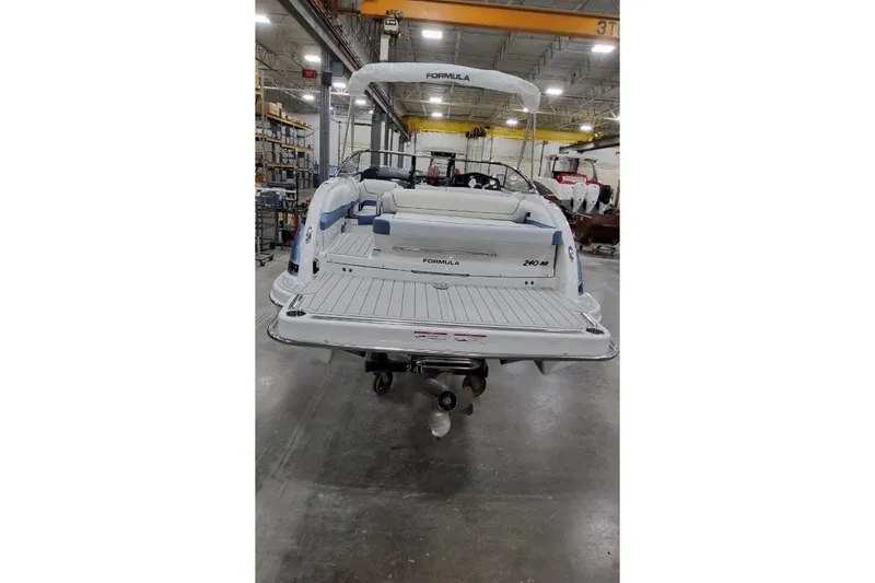 Slide: The Image of 2026 Formula 240 Bowrider boat in a warehouse, showcasing sleek design and spacious deck. - 5