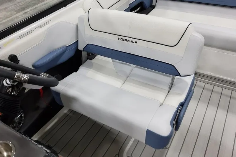 Slide: The Image of Interior of 2026 Formula 240 Bowrider boat with white and blue seating. - 8