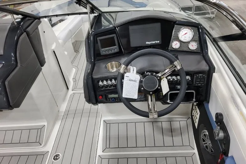 Slide: The Image of 2026 Formula 240 Bowrider dashboard with steering wheel, gauges, and navigation system. - 9