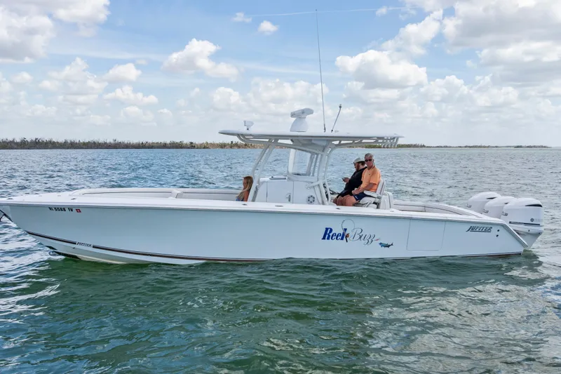 The Image of 2015 Jupiter 34 HFS boat on water with passengers, clear sky background. - 0