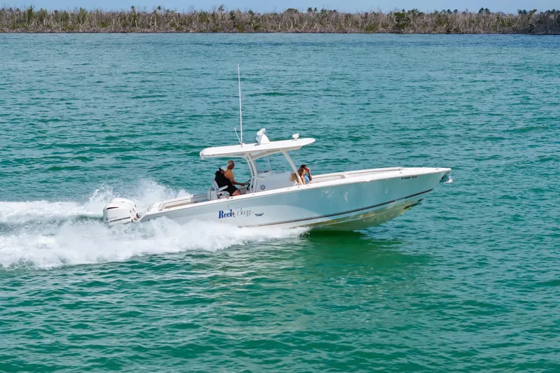 Slide: The Image of 2015 Jupiter 34 HFS boat cruising on clear blue water. - 10