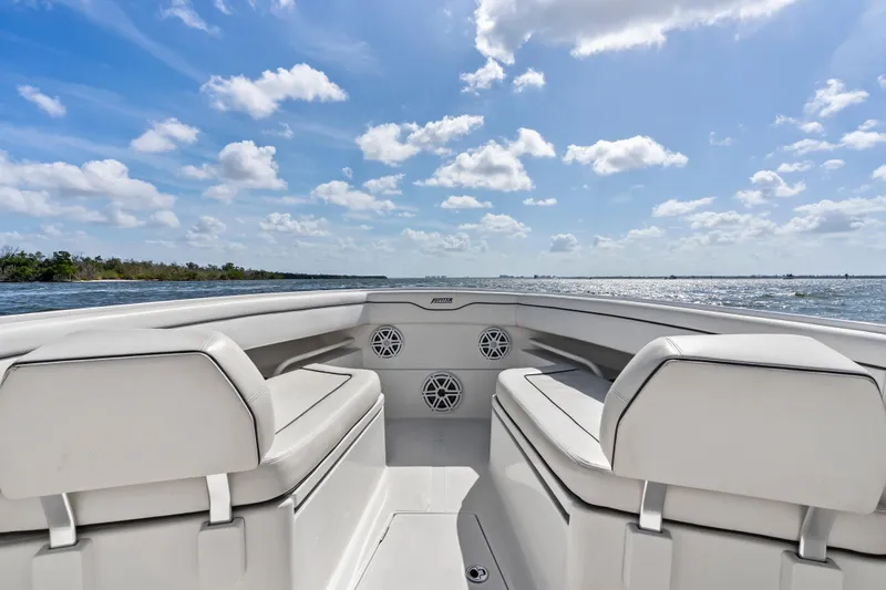 Slide: The Image of 2015 Jupiter 34 HFS boat interior with white seating, ocean view, and blue sky. - 12