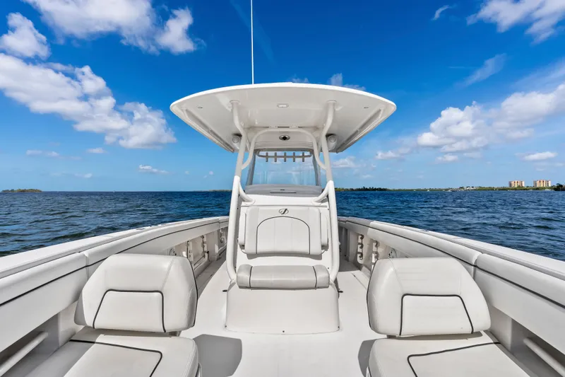 Slide: The Image of 2015 Jupiter 34 HFS boat on open water under a clear blue sky. - 15
