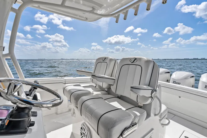 Slide: The Image of 2015 Jupiter 34 HFS boat interior with dual seats, ocean view, and clear sky. - 18