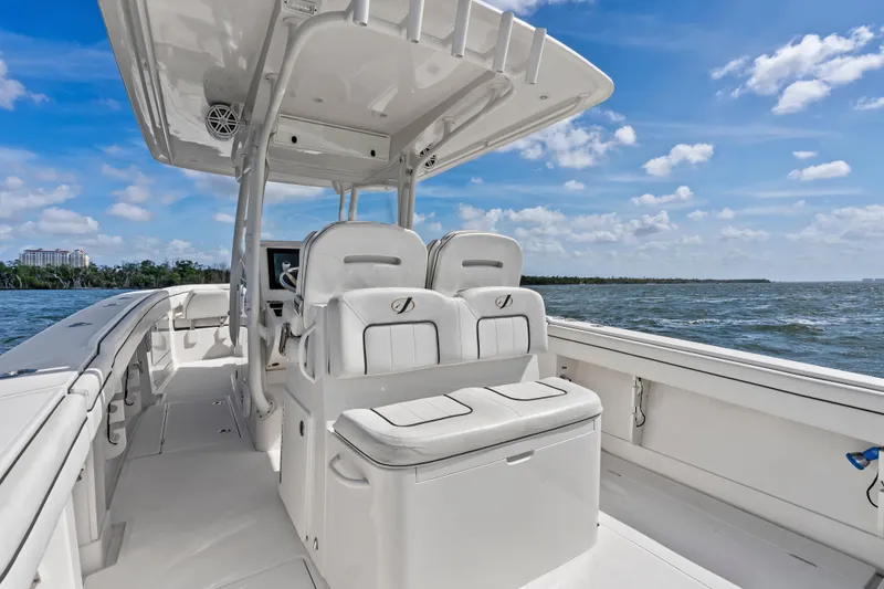 Slide: The Image of 2015 Jupiter 34 HFS boat interior with helm seats, ocean view, and clear sky. - 24