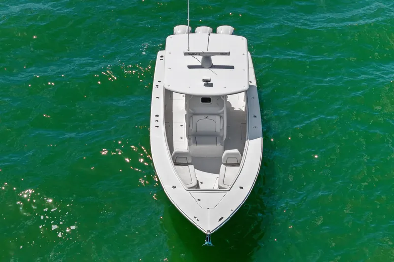 Slide: The Image of Overhead view of a 2015 Jupiter 34 HFS boat on vibrant green water. - 4