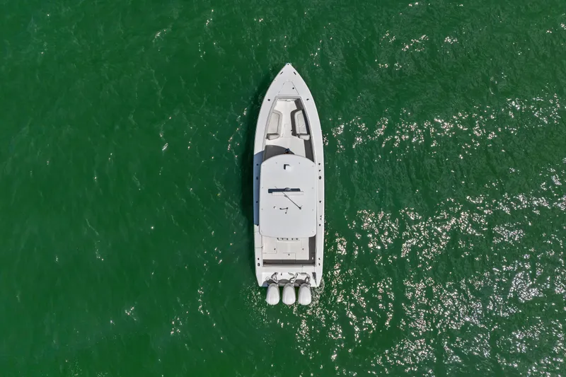 Slide: The Image of Aerial view of 2015 Jupiter 34 HFS boat on vibrant green water. - 5