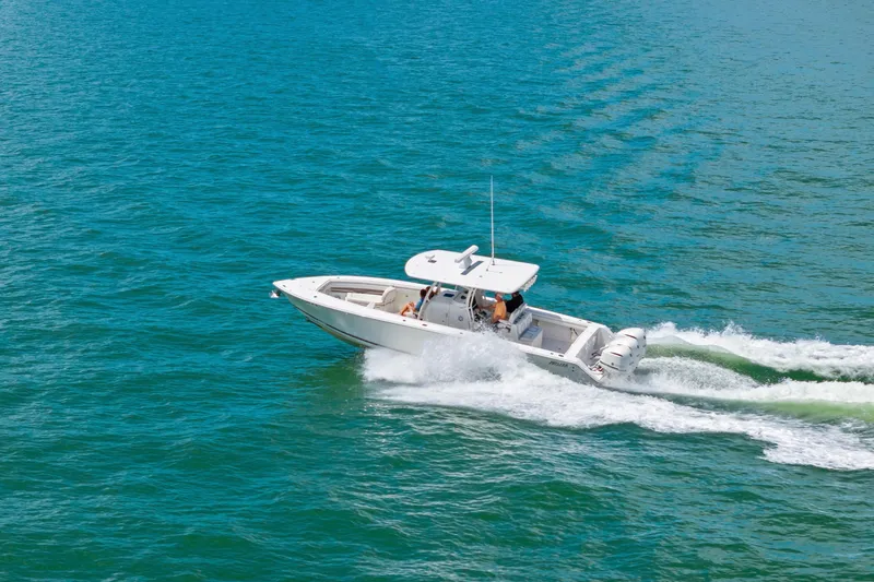 Slide: The Image of 2015 Jupiter 34 HFS boat cruising on clear blue water. - 8