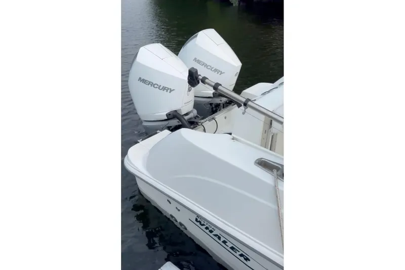 Slide: The Image of 2023 Boston Whaler 250 Outrage with twin Mercury outboard engines on water. - 3