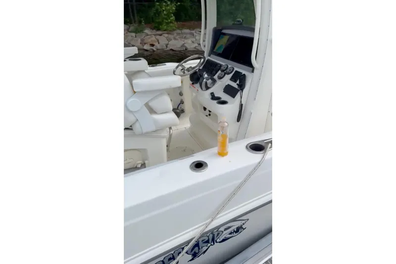 Slide: The Image of 2023 Boston Whaler 250 Outrage boat interior with steering console and seating. - 4